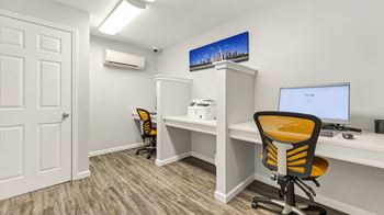 An office with a computer and a desk with a chair